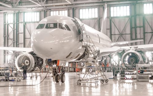 Passenger aircraft on maintenance of engine and fuselage repair in airport hangar